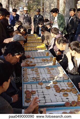 China, Xinjiang, Urumqi, line of people playing mah-jong outdoors View Large Photo Image Stock Image - China, Xinjiang, Urumqi, line of people playing mah-jong outdoors. Fotosearch