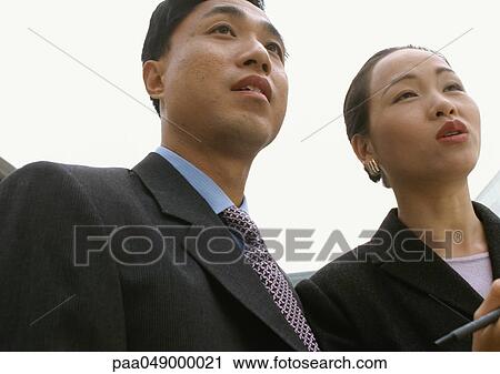 Man and woman side by side, low angle view View Large Photo Image Stock Image - Man and woman side by side, low angle view. Fotosearch