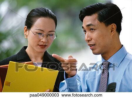 Man and woman side by side, woman holding folders, head and shoulders View Large Photo Image Stock Image - Man and woman side by side, woman holding folders, head and shoulders. Fotosearch