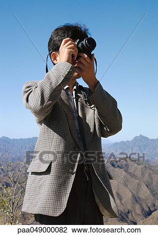 Man using camera View Large Photo Image Stock Image - Man using camera. Fotosearch