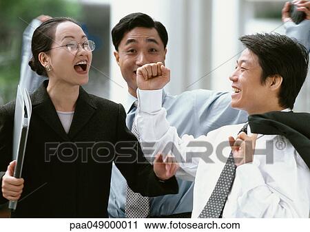 Two men and a woman smiling, outside View Large Photo Image Stock Image - Two men and a woman smiling, outside. Fotosearch