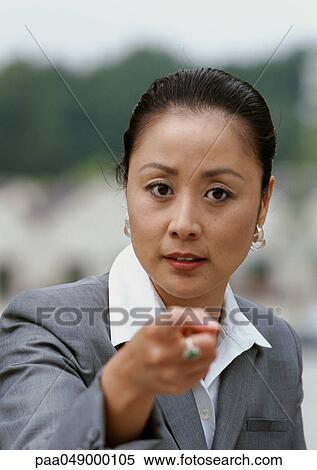 Woman pointing finger at camera, portrait View Large Photo Image Stock Photography - Woman pointing finger at camera, portrait. Fotosearch