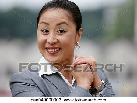 Woman smiling, hands together, portrait View Large Photo Image Stock Photo - Woman smiling, hands together, portrait. Fotosearch