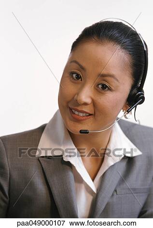 Woman wearing headset, looking at camera, portrait View Large Photo Image Stock Photo - Woman wearing headset, looking at camera, portrait. Fotosearch