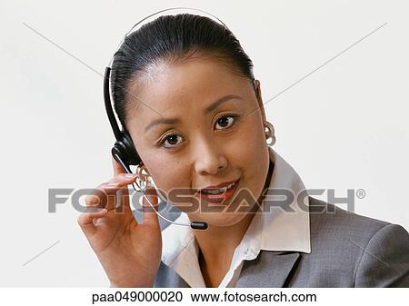 Woman wearing headset, portrait View Large Photo Image Stock Image - Woman wearing headset, portrait. Fotosearch