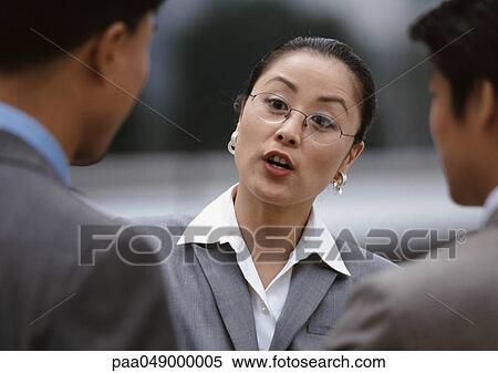 Woman with open mouth, two men in foreground View Large Photo Image Stock Photography - Woman with open mouth, two men in foreground. Fotosearch