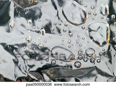 Drops on metallic surface, close-up View Large Photo Image Stock Photograph - Drops on metallic surface, close-up. Fotosearch