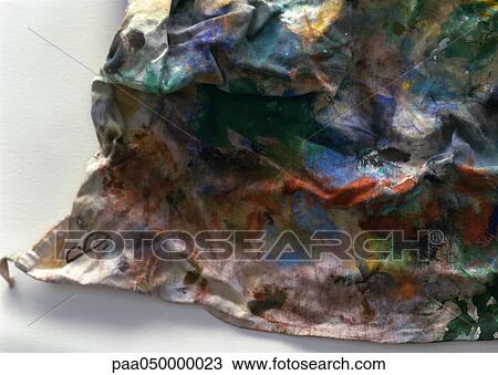 Stock Image - Rag covered in paint, close-up. Fotosearch