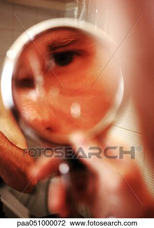Stock Image - Eye reflected in mirror, blurred. Fotosearch