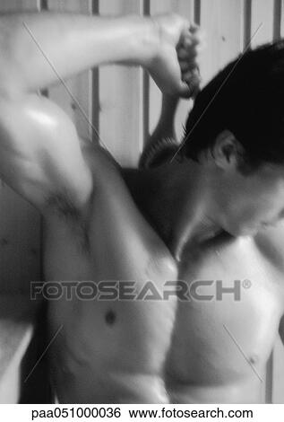 Stock Photograph - Man brushing back in sauna, close-up, b&w. Fotosearch