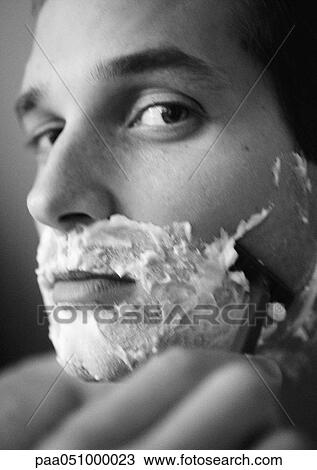 Stock Image - Man shaving, close-up, b&w. Fotosearch