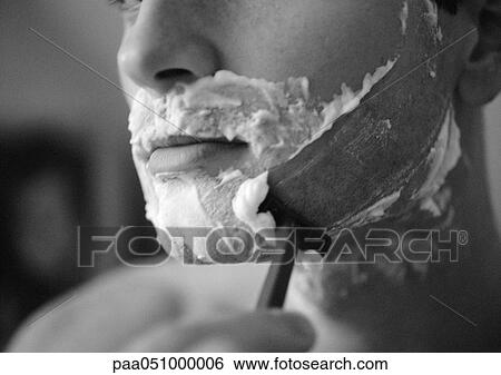 Stock Photograph - Man shaving, close-up, b&w. Fotosearch