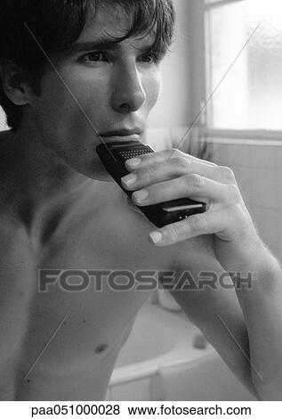 Man using electric razor, b&w View Large Photo Image Stock Photo - Man using electric razor, b&w. Fotosearch