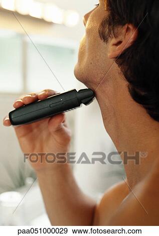 Man using electric razor under chin, close-up, side view View Large Photo Image Stock Photo - Man using electric razor under chin, close-up, side view. Fotosearch