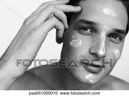 Man with dabs of moisturizer on face, looking at camera, portrait, b&w View Large Photo Image Stock Image - Man with dabs of moisturizer on face, looking at camera, portrait, b&w. Fotosearch