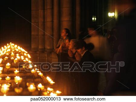 France, Paris, Notre Dame Cathedral, people praying next to candles View Large Photo Image Stock Image - France, Paris, Notre Dame Cathedral, people praying next to candles. Fotosearch