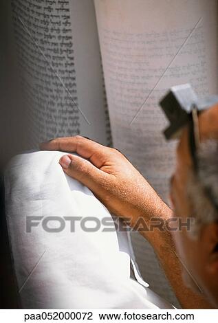 Stock Image - Hand, Torah in background. Fotosearch