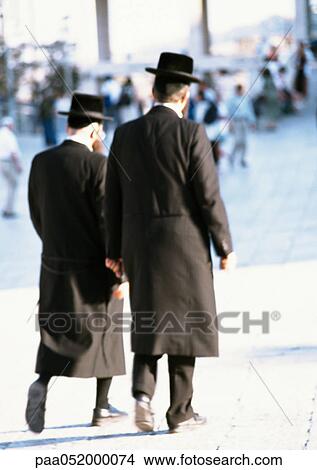 Picture - Israel, Jerusalem, Orthodox Jews walking in street, rear view. Fotosearch