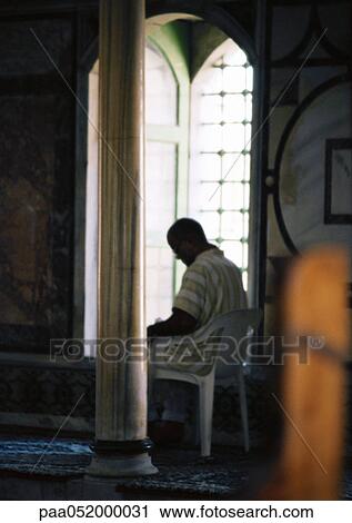 Israel, Jerusalem, person sitting in plastic chair in mosque, next to window View Large Photo Image Stock Image - Israel, Jerusalem, person sitting in plastic chair in mosque, next to window. Fotosearch