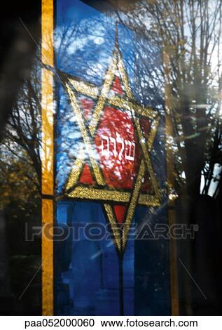 Stock Image - Stained-glass window with Star of David and trees, superimposition of images. Fotosearch