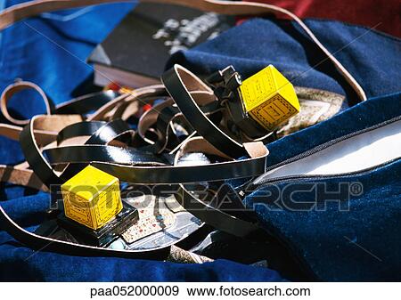 Tefillin (Jewish prayer objects consisting of leather straps and little boxes containing Torah), close-up View Large Photo Image Stock Photo - Tefillin (Jewish prayer objects consisting of leather straps and little boxes containing Torah), close-up. Fotosearch