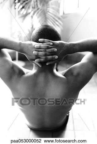 Bare-chested man doing abdominal exercises, hands behind head, rear view, b&w View Large Photo Image Stock Image - Bare-chested man doing abdominal exercises, hands behind head, rear view, b&w. Fotosearch