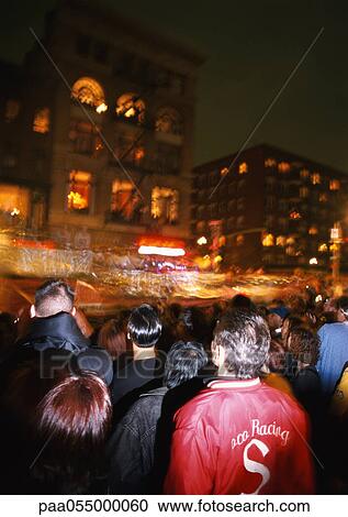 Stock Image - Crowd in street at night, blurred motion. Fotosearch