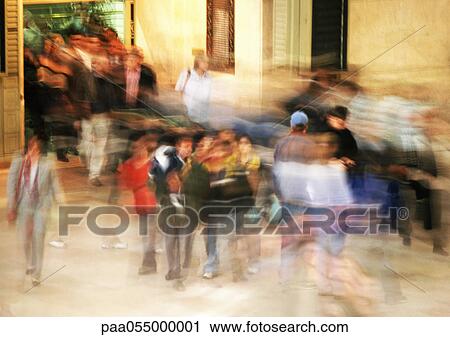 Stock Image - Groups of people, outside, blurred motion. Fotosearch