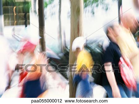 Stock Image - People in street, blurred. Fotosearch
