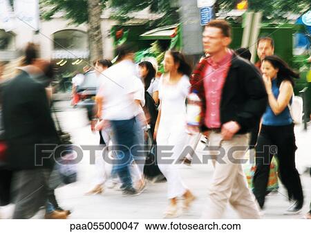Stock Photo - People walking in street, blurred. Fotosearch