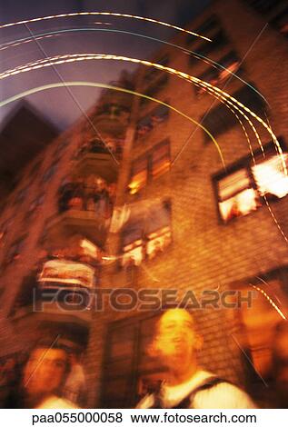 Two people standing at foot of building, low angle view, blurred View Large Photo Image Stock Photo - Two people standing at foot of building, low angle view, blurred. Fotosearch