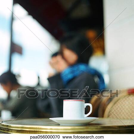 Cup of coffee on table at cafe terrace View Large Photo Image Stock Image - Cup of coffee on table at cafe terrace. Fotosearch