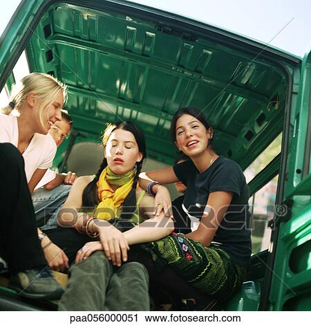 Group of teenagers sitting in back of van, low angle view View Large Photo Image Stock Image - Group of teenagers sitting in back of van, low angle view. Fotosearch