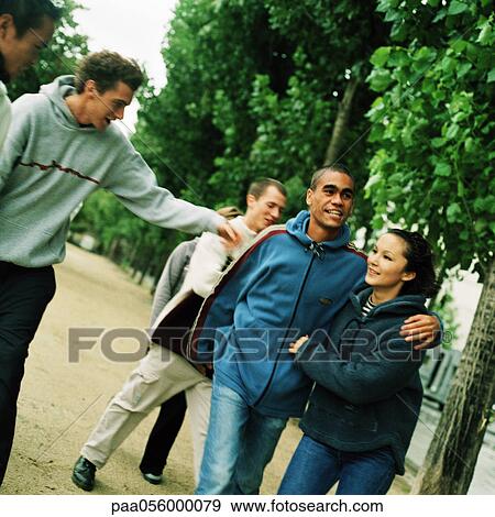 Group of young people in park View Large Photo Image Stock Photo - Group of young people in park. Fotosearch