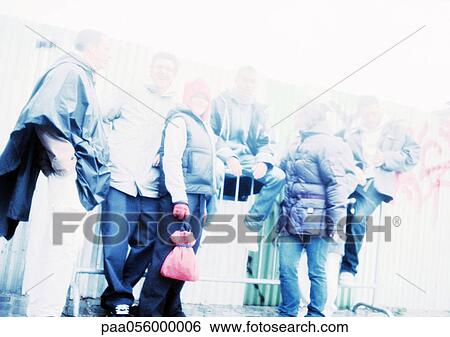 Stock Photograph - Group of young people outside, blurred. Fotosearch