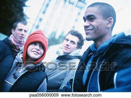 Group of young people outside, building in background View Large Photo Image Stock Photo - Group of young people outside, building in background. Fotosearch