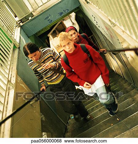 Three teenagers climbing stairs, high angle view View Large Photo Image Stock Photo - Three teenagers climbing stairs, high angle view. Fotosearch