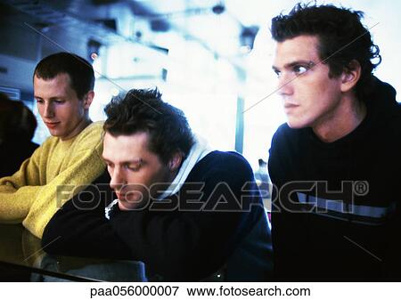 Three young men side by side View Large Photo Image Stock Photo - Three young men side by side. Fotosearch