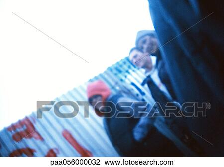 Young people in street, low angle view, blurred View Large Photo Image Stock Image - Young people in street, low angle view, blurred. Fotosearch