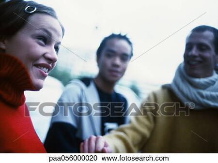 Young people outdoors, smiling View Large Photo Image Stock Image - Young people outdoors, smiling. Fotosearch