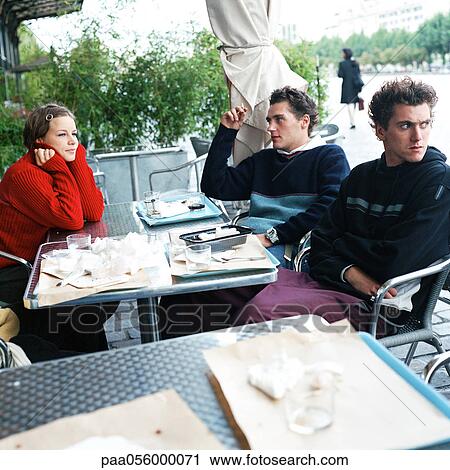 Young people sitting at restaurant terrace View Large Photo Image Stock Image - Young people sitting at restaurant terrace. Fotosearch