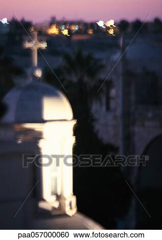 Stock Image - Christian cross on dome, rooftops in background. Fotosearch