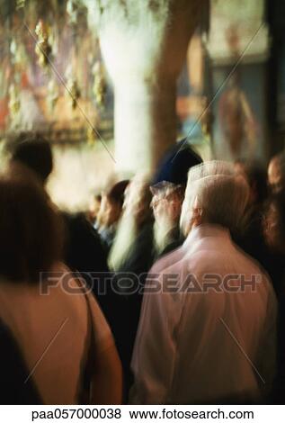 Stock Photo - Crowd of people standing in church, blurred. Fotosearch