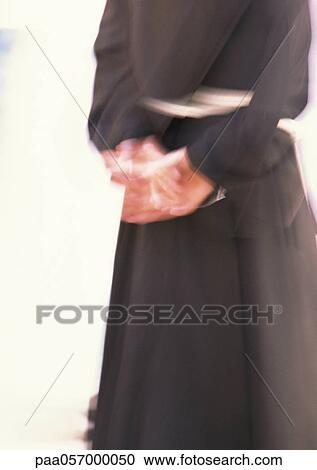 Monk, hands behind back, mid section, blurred View Large Photo Image Stock Image - Monk, hands behind back, mid section, blurred. Fotosearch