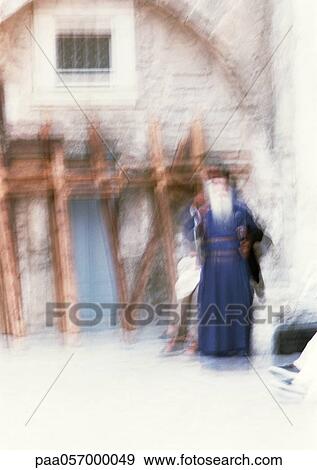 Orthodox priest standing in front of old edifice, blurred View Large Photo Image Stock Photo - Orthodox priest standing in front of old edifice, blurred. Fotosearch