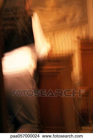 Picture - Person kneeling in church, rear view, blurred. Fotosearch
