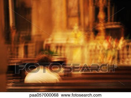 Person sitting in a church, blurred View Large Photo Image Stock Photo - Person sitting in a church, blurred. Fotosearch