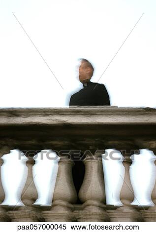 Priest standing behind rail, low angle view, blurred View Large Photo Image Stock Photography - Priest standing behind rail, low angle view, blurred. Fotosearch