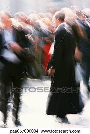 Priest walking in crowd outside, blurred View Large Photo Image Picture - Priest walking in crowd outside, blurred. Fotosearch