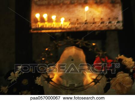 Religious statue in front of candles View Large Photo Image Stock Photo - Religious statue in front of candles. Fotosearch